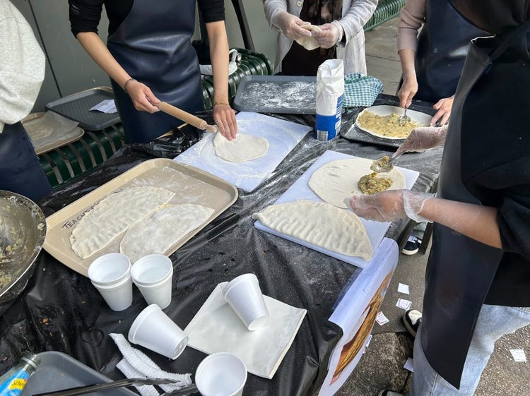 Pairs of hands preparing traditional Afghan bread