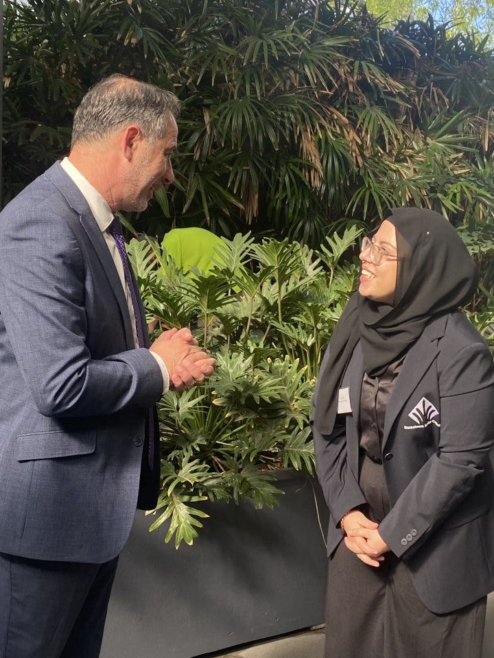 Female student leader talking to The Hon. Jihad DIB, MP